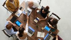 People shaking hands at a conference table