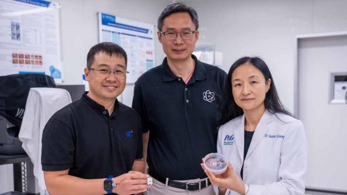 Representatives from NTU Singapore, Procter & Gamble, and Agency for Science, Technology and Research pose side-by-side while showing the HapSense ring-type device for skincare cosmetic product analysis.