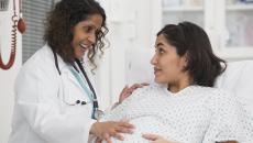 Healthcare provider evaluating a pregnant person 