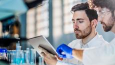 Two people looking at a tablet in a laboratory