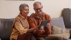 Two elderly persons using a tablet computer