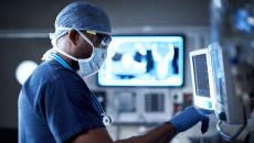 A surgeon looking at a monitor.