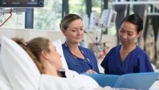 Virtus Health nurses assisting a patient in bed