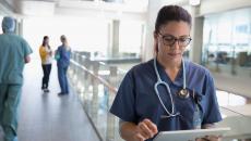 Healthcare provider looking at a tablet