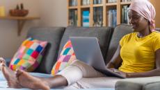 Person using laptop on a couch